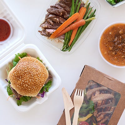 Delicious to go lunches including a burder steak and carrots, grilled chicken salad, and lentil soup