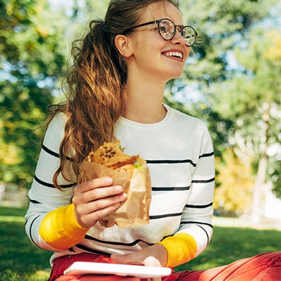 A happy bruin enjoys their to-go lunch